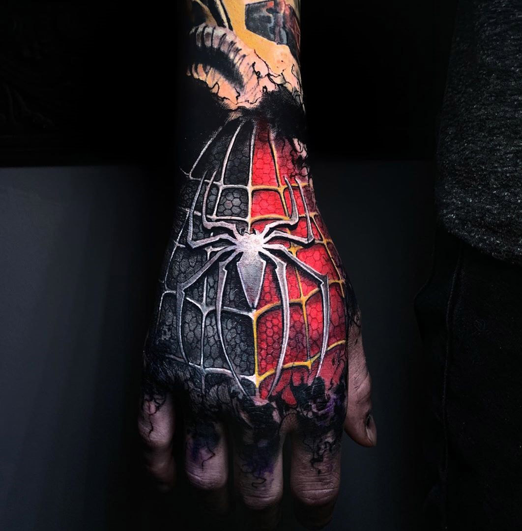 A Person With A Spider Man Tattoo On Their Arm