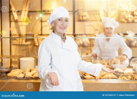 Smiling Female Bakery Worker Showing Around Her Workplace Stock Image