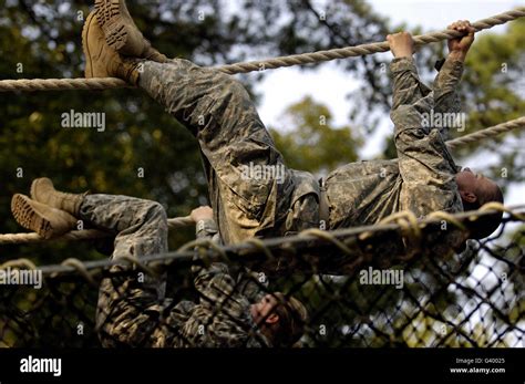 U S Army Recruits Shuffling Down A Rope Obstacle During Basic Combat